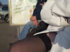 Young woman in stockings at the bus stop